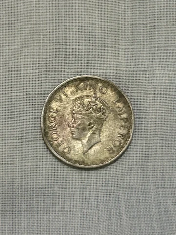 British India 1942 Half Rupee (8 Annas), King George VI, and it is a silver coin. The standard 1942 Bombay issue is about 5.83 g, 24.1 mm, and 50% silver.